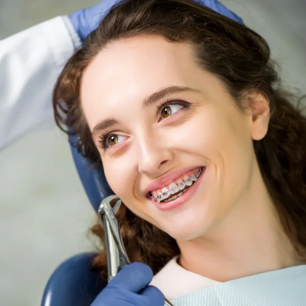 Smiling woman with braces at the dentist
