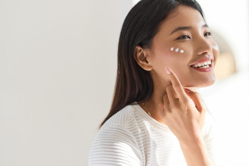 Woman applying moisturiser