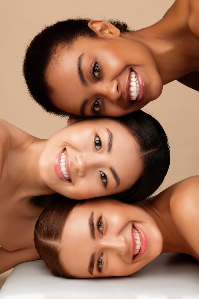 Three smiling women with healthy skin