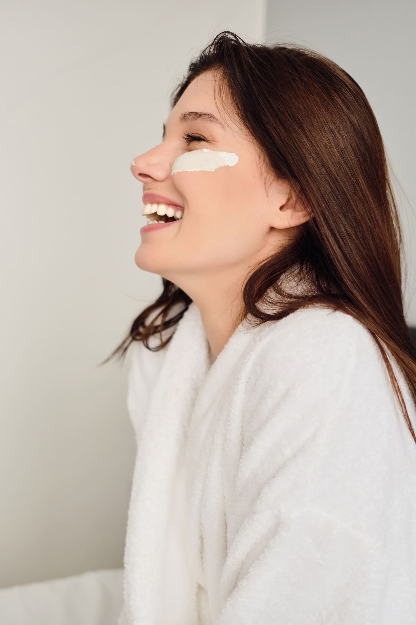 Cheerful woman with cosmetic mask